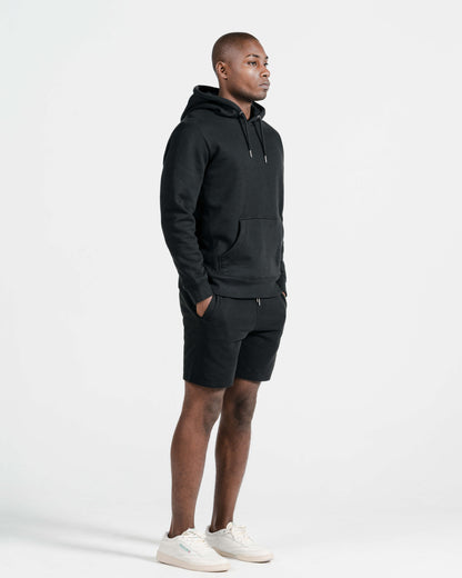 Model wearing Robenti Black Organic Cotton Sweatshorts